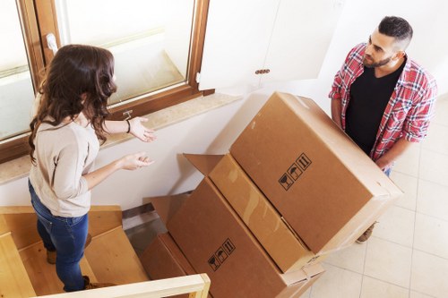 Movers unloading household items at a new property