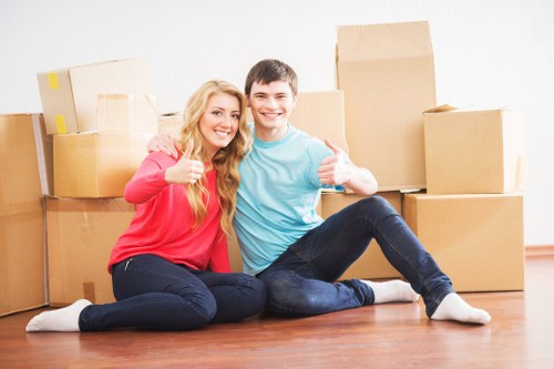 Local moving team handling packed boxes in Croftonpark
