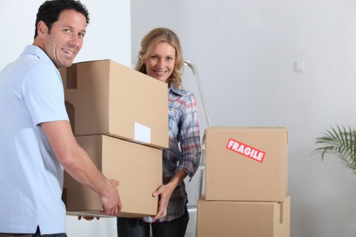 Removal crew handling furniture in a Croftonpark flat move